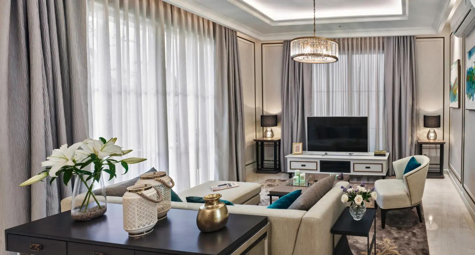 A modern classic-style living room with natural lighting, elegant furniture, and luxurious decorative accents.